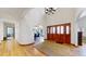 Inviting foyer featuring hardwood floors, arched doorways, and a glimpse into the dining area and hallway at 10346 E Crestridge Ln, Englewood, CO 80111