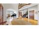 Grand foyer with hardwood floors, curved staircase, and piano at 10346 E Crestridge Ln, Englewood, CO 80111