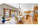 Bright kitchen featuring an island, wooden cabinets and a breakfast nook with sliding doors to the deck at 10346 E Crestridge Ln, Englewood, CO 80111