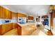 Spacious kitchen featuring wooden cabinets, stainless steel appliances, granite countertops, and hardwood floors at 10346 E Crestridge Ln, Englewood, CO 80111