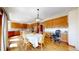 Open-concept kitchen and dining area with wood floors, oak cabinets and granite counters at 10346 E Crestridge Ln, Englewood, CO 80111