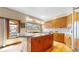 Updated kitchen with granite countertops, island with cooktop, and ample cabinet space at 10346 E Crestridge Ln, Englewood, CO 80111