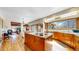Bright kitchen with hardwood floors, a large island with granite countertops, and a window overlooking the backyard at 10346 E Crestridge Ln, Englewood, CO 80111