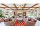 Spacious living room with coffered ceilings, brick accents, and arched windows provides lots of natural light at 10346 E Crestridge Ln, Englewood, CO 80111