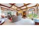 Inviting living room with coffered ceilings, brick accent wall, and large windows at 10346 E Crestridge Ln, Englewood, CO 80111