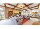 Cozy living room with brick fireplace, coffered ceilings and neutral furniture with a glimpse of the kitchen at 10346 E Crestridge Ln, Englewood, CO 80111