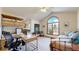 Bright home office featuring a daybed, a large arched window, and functional desk and storage units at 10346 E Crestridge Ln, Englewood, CO 80111
