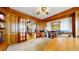 Elegant wood-paneled home office with French doors, a view of the staircase, and a large desk at 10346 E Crestridge Ln, Englewood, CO 80111