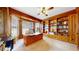 Wood-paneled home office with built-in bookshelves, a large desk, and a bright window at 10346 E Crestridge Ln, Englewood, CO 80111