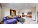 Comfortable sitting area with a plush purple sectional and access to the bedroom at 10346 E Crestridge Ln, Englewood, CO 80111