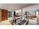 Spacious basement workout room with a treadmill, punching bag, and ample natural light at 10346 E Crestridge Ln, Englewood, CO 80111