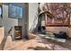 An outside backyard with a patio and small outdoor seating on a colorful rug in front of a multilevel outdoor wood deck at 1675 S Steele St, Denver, CO 80210
