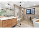 Luxurious bathroom featuring dual shower heads, tiled walls, and glass door at 1675 S Steele St, Denver, CO 80210
