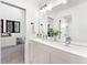Contemporary bathroom with double vanity, large mirror, and modern fixtures at 1675 S Steele St, Denver, CO 80210