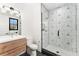 Contemporary bathroom featuring a modern vanity, decorative tile shower, and glass door at 1675 S Steele St, Denver, CO 80210