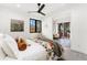 Bright bedroom with ceiling fan, stylish decor, and an outdoor view through sliding glass doors at 1675 S Steele St, Denver, CO 80210