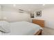 Light and bright bedroom with white bedding, natural-wood-colored furniture, and a window allowing natural light in at 1675 S Steele St, Denver, CO 80210
