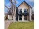 Stunning modern home with a white brick facade, black accents, balcony, and professionally landscaped yard at 1675 S Steele St, Denver, CO 80210