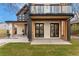 Modern home's covered patio featuring white brick, black accents, and inviting space, seamlessly blending indoor-outdoor living at 1675 S Steele St, Denver, CO 80210