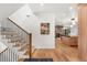 Inviting entryway featuring a staircase and open view into the kitchen and living area at 1675 S Steele St, Denver, CO 80210