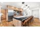 Modern kitchen with a long island, stainless steel appliances, and breakfast bar seating, offering a stylish gathering space at 1675 S Steele St, Denver, CO 80210