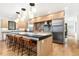 Modern kitchen with a large island, stainless steel appliances, and sleek cabinetry, perfect for cooking and entertaining at 1675 S Steele St, Denver, CO 80210