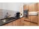 Modern kitchen featuring wooden cabinetry, sleek countertops, stainless steel appliances, and stylish fixtures at 1675 S Steele St, Denver, CO 80210