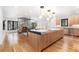 Open kitchen featuring a large island, modern lighting, and connection to a cozy living area with a fireplace at 1675 S Steele St, Denver, CO 80210