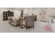 Living room with neutral-colored furniture, grey floors, a desk and shelving, and an open door for easy access at 1675 S Steele St, Denver, CO 80210