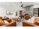Inviting living room with cozy leather furniture, modern fireplace, ceiling fan, and plenty of natural light at 1675 S Steele St, Denver, CO 80210