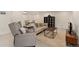 Open living room with neutral decor, an accent chair, couches and decorative shelving, with a dining table in the background at 1675 S Steele St, Denver, CO 80210