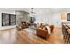 Spacious living space features a modern fireplace, a ceiling fan, hardwood floors, and ample natural light at 1675 S Steele St, Denver, CO 80210
