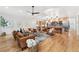 Spacious open-concept living area flows into a modern kitchen with bar seating and stainless steel appliances at 1675 S Steele St, Denver, CO 80210