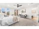 Bright primary bedroom with ceiling fan, neutral decor, and sliding door access to a balcony at 1675 S Steele St, Denver, CO 80210