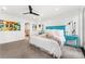 Bright main bedroom featuring blue accents, white linens, and a ceiling fan at 1675 S Steele St, Denver, CO 80210