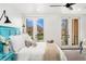 Airy bedroom with white linens, gray carpet, and French doors opening to outdoor view at 1675 S Steele St, Denver, CO 80210