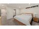 Bedroom with modern decor, white walls, grey carpet, a king-sized bed, and an adjoining bathroom at 1675 S Steele St, Denver, CO 80210