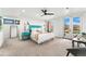 Bright and airy primary bedroom with modern furniture, ceiling fan, and access to a private balcony at 1675 S Steele St, Denver, CO 80210