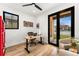 Bright office with desk, ergonomic chair, and large black-framed window at 1675 S Steele St, Denver, CO 80210