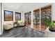 Sunroom with tile flooring, cozy chairs, and sliding glass doors that lead to an outdoor deck at 1675 S Steele St, Denver, CO 80210