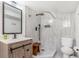 Modern bathroom featuring a stylish vanity, walk-in shower with patterned tile, and contemporary fixtures at 9093 Dudley St, Westminster, CO 80021