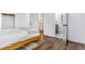 Light-filled bedroom with hardwood floors and an open door to a bathroom en suite at 9093 Dudley St, Westminster, CO 80021