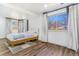 Well-lit bedroom with hardwood floors, large windows, and neutral decor at 9093 Dudley St, Westminster, CO 80021