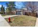 Property features a two-car garage, wooden fence, and a small patch of grass at 9093 Dudley St, Westminster, CO 80021