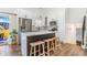 Contemporary kitchen featuring stainless steel appliances, a spacious island, and sleek white cabinets at 9093 Dudley St, Westminster, CO 80021