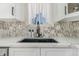 Close-up of a modern kitchen sink with marble countertops and stylish black faucet at 9093 Dudley St, Westminster, CO 80021