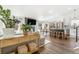 Spacious living room featuring hardwood floors, modern furniture, a fireplace, and an open connection to the kitchen at 9093 Dudley St, Westminster, CO 80021