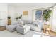 Spacious living room with lots of natural light, a comfortable gray couch, and nice decor at 9093 Dudley St, Westminster, CO 80021