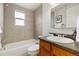Clean bathroom featuring tiled walls, granite vanity, and a shower-tub combo at 1419 Detroit St # 25, Denver, CO 80206