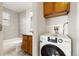 Simple bathroom with a bathtub and wood cabinets at 1419 Detroit St # 25, Denver, CO 80206